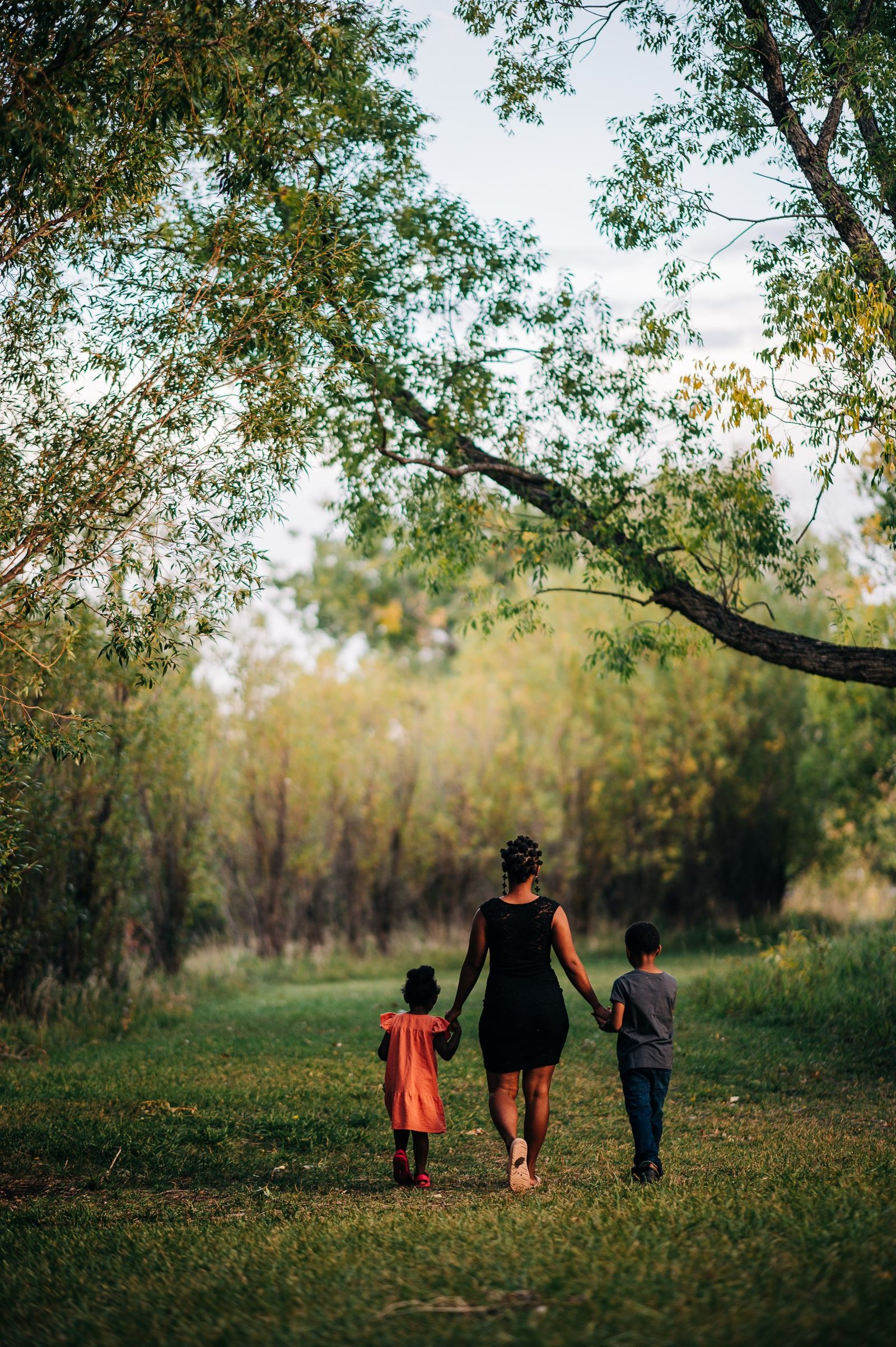 FreeBlackmotherhood founder Ambreia, public speaker, facilitator, and motherhood scholar, walking with her children in the woods